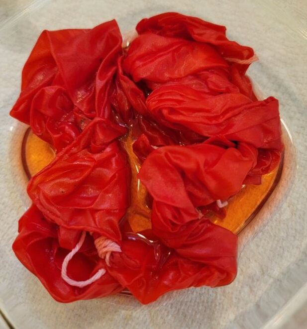 crumpled red scarf in clear bowl