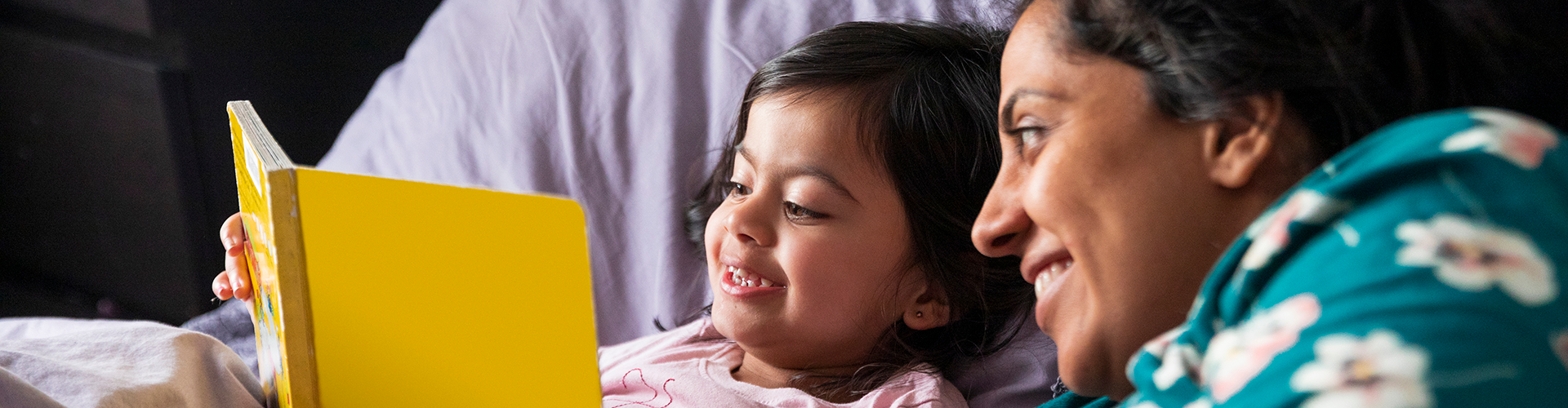 little girl and mom reading