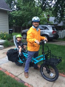 dad and kid ready to ride on cargo bike