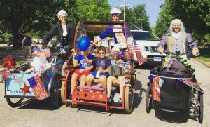 Cargo bikes loaded and driving in Collins Park 4th of July parade
