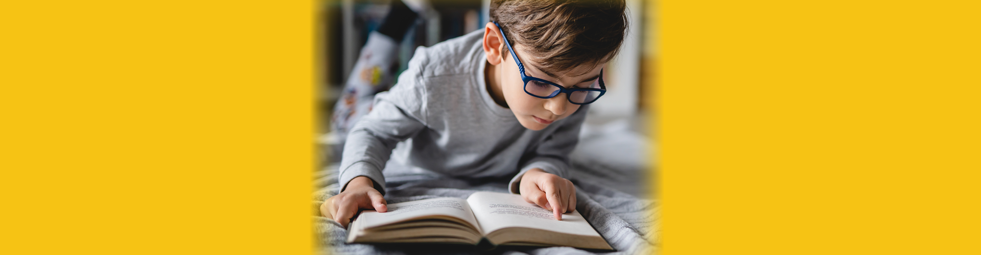 boy with glasses reading